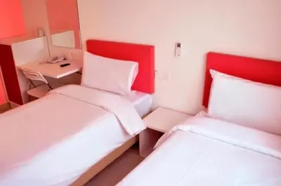 a small room with two beds and a desk at YY318 Hotel Bukit Bintang in Kuala Lumpur