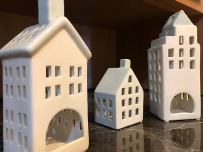 three toy houses and a building on a table at Modern 3BR with Iconic KLCC Towers Skyline Views and Parking in Kuala Lumpur