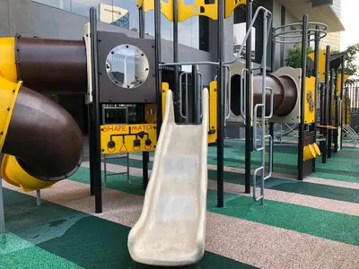 a playground with a slide in a building at Modern 3BR with Iconic KLCC Towers Skyline Views and Parking in Kuala Lumpur