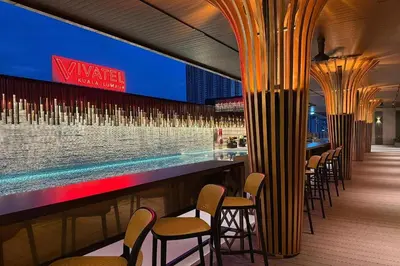 a bar with chairs and a swimming pool at Vivatel Kuala Lumpur in Kuala Lumpur