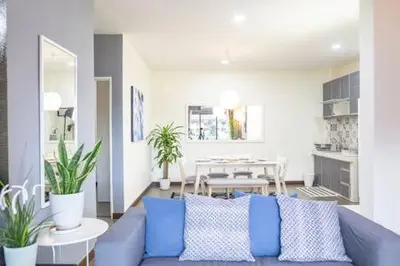 a living room with a blue couch and a table at Omar's Place 1 in Kuala Lumpur