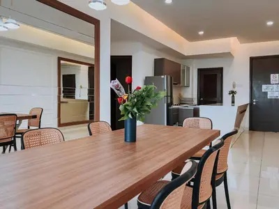 a table with a vase of flowers on it in a kitchen at Regalia Residence The Sky Pool Suite in Kuala Lumpur
