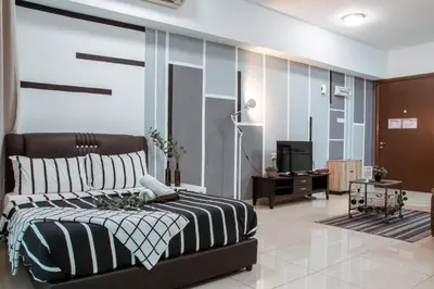 a bedroom with a bed and a television in it at Regalia Residence The Sky Pool Suite in Kuala Lumpur