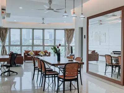 a dining room with a table and chairs at Regalia Residence The Sky Pool Suite in Kuala Lumpur