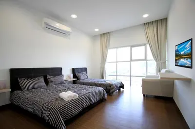 a bedroom with a bed and a chair in it at Zeta Desky in Kuala Lumpur