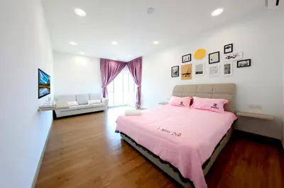a bedroom with a bed with pink sheets and pink pillows at Zeta Desky in Kuala Lumpur