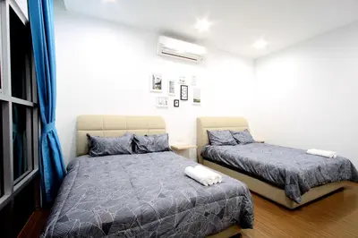 a bedroom with two beds and a window at Zeta Desky in Kuala Lumpur