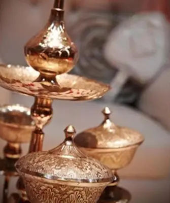 a group of gold vases sitting on a table at Premiera Hotel Kuala Lumpur in Kuala Lumpur