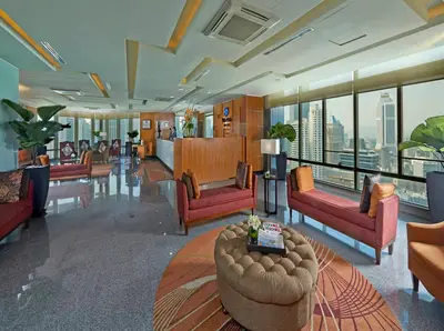 a large room with couches and tables and windows at Premiera Hotel Kuala Lumpur in Kuala Lumpur