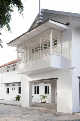 a white building with a balcony on it at YWCA Kuala Lumpur in Kuala Lumpur