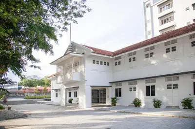 an exterior view of a white building at YWCA Kuala Lumpur in Kuala Lumpur