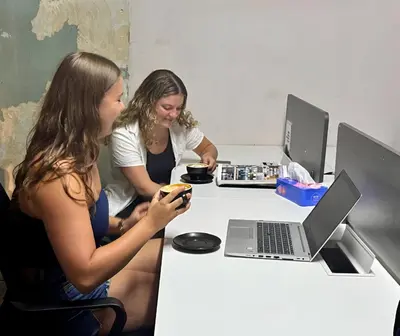 two women sitting at a desk with a laptop computer at Mingle Highstreet - CoWorking Hub in Kuala Lumpur