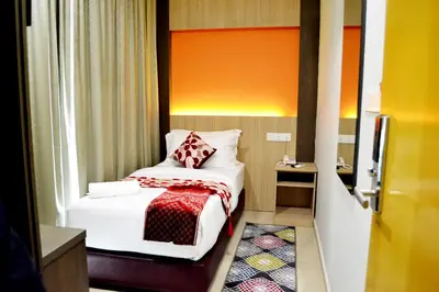 a small room with a bed and a window at Sky Hotel @ Pudu in Kuala Lumpur