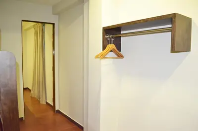 a hallway with a door with a hanger on the wall at Sky Hotel @ Pudu in Kuala Lumpur
