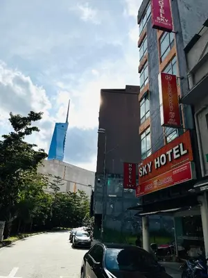 a city street with cars parked in front of a hotel at Sky Hotel @ Pudu in Kuala Lumpur