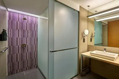 a bathroom with a shower and a sink at Aloft Kuala Lumpur Sentral in Kuala Lumpur