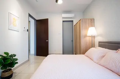 a bedroom with a white bed and a plant at 3 Rooms Elegant Minimalist Design Setapak 15min KLCC in Kuala Lumpur