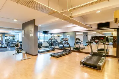 a gym with several treadmills and exercise bikes at Wedgewood Residences in Kuala Lumpur