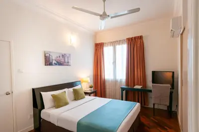a bedroom with a bed and a window at Wedgewood Residences in Kuala Lumpur