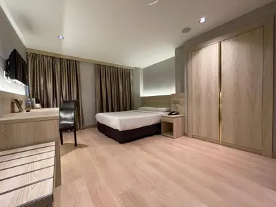 a hotel room with a bed and a desk at Hotel Imperial in Kuala Lumpur
