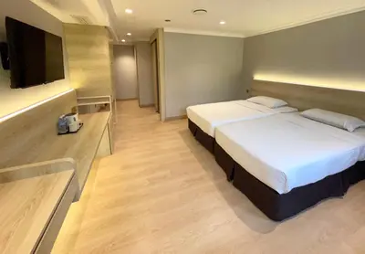 a hotel room with a bed and a flat screen tv at Hotel Imperial in Kuala Lumpur