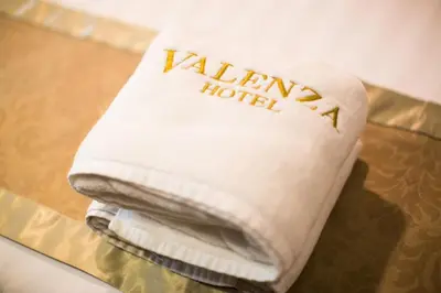 a white towel with the name talima hotel on it at Hotel Valenza in Kuala Lumpur