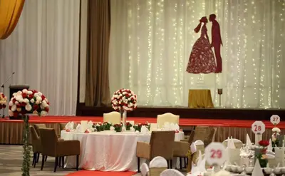 a table with a bride and groom on a stage at Better Residence Suite at Times Square Bukit bintang kl in Kuala Lumpur
