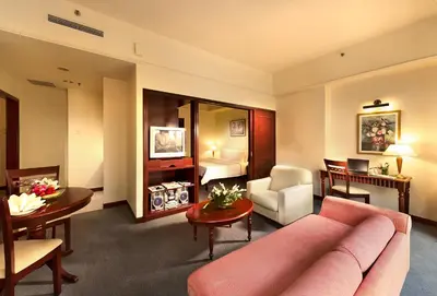 a living room with a couch and a room with a bed at Better Residence Suite at Times Square Bukit bintang kl in Kuala Lumpur