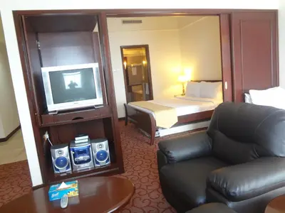 a hotel room with a couch and a tv and a bed at Better Residence Suite at Times Square Bukit bintang kl in Kuala Lumpur