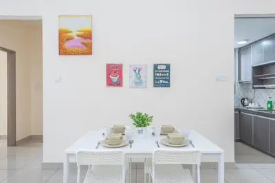a white dining room with a white table and chairs at PV21 Setapak, Wangsamaju, Melawati, 15min to KLCC B36a in Kuala Lumpur
