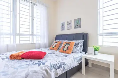 a white bedroom with a bed with orange pillows at PV21 Setapak, Wangsamaju, Melawati, 15min to KLCC B36a in Kuala Lumpur