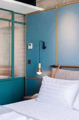 a bedroom with a bed with a blue wall at KLoe Hotel in Kuala Lumpur