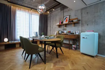 a kitchen and dining room with a table and a refrigerator at KLoe Hotel in Kuala Lumpur