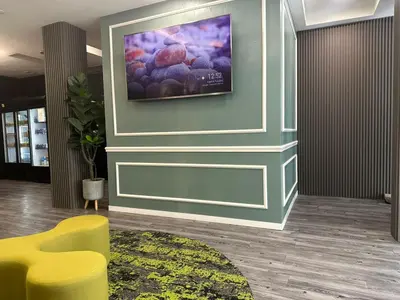 a living room with a tv on the wall at D'Garden Hotel Kuala Lumpur in Kuala Lumpur