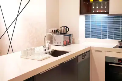 a kitchen with a sink and a microwave at Tropicana The Residence KLCC in Kuala Lumpur