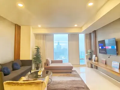 a living room with a couch and a tv at Tropicana The Residence KLCC in Kuala Lumpur