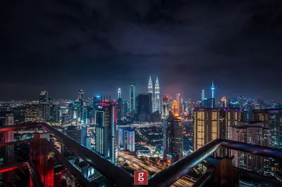a view of a city skyline at night at EXPRESSIONZ KLCC by Gsuites in Kuala Lumpur