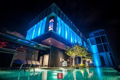 a building with a swimming pool at night at EXPRESSIONZ KLCC by Gsuites in Kuala Lumpur