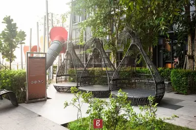 a group of benches in a garden with trees at EXPRESSIONZ KLCC by Gsuites in Kuala Lumpur