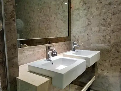 a bathroom with two sinks and a mirror at Dorsett Residences Sri Hartamas KL in Kuala Lumpur