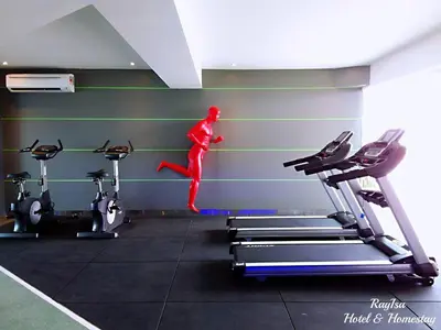 a man is jumping off a treadmill in a gym at Dorsett Residences Sri Hartamas KL in Kuala Lumpur