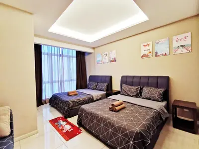 a bedroom with two beds and a window at Dorsett Residences Sri Hartamas in Kuala Lumpur