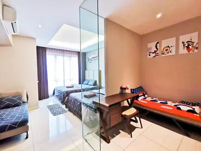 a room with a bedroom with a desk and a bed at Dorsett Residences Sri Hartamas in Kuala Lumpur