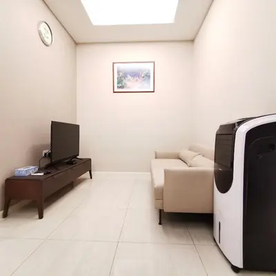 a living room with a couch and a tv at SKY POOL Luxury Suite 2-4Pax at KL City in Kuala Lumpur