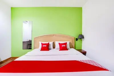 a bed with red pillows in a green bedroom at OYO 89652 Bjorn Boutique Hotel in Kuala Lumpur