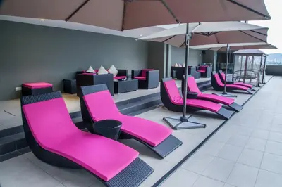 a row of pink chairs in a waiting room at #PERFECT# Location BUKIT BINTANG Apartment in Kuala Lumpur