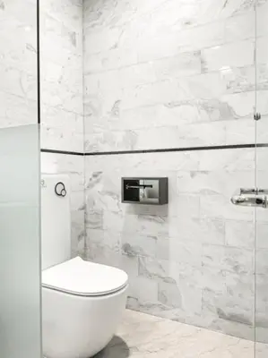 a white toilet in a bathroom with marble walls at The Platinum KLCC 2 in Kuala Lumpur