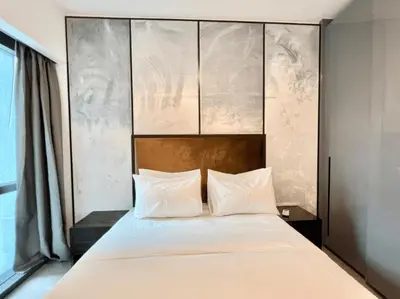 a bedroom with a large bed with white pillows at The Platinum KLCC 2 in Kuala Lumpur