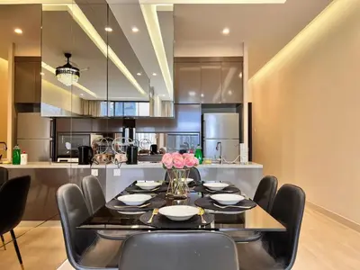 a dining room with a table and chairs and a kitchen at Dorsett Residences Bukit Bintang in Kuala Lumpur