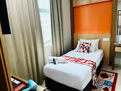 a hotel room with two beds and a window at Prime Hotel at TRX Tower in Kuala Lumpur